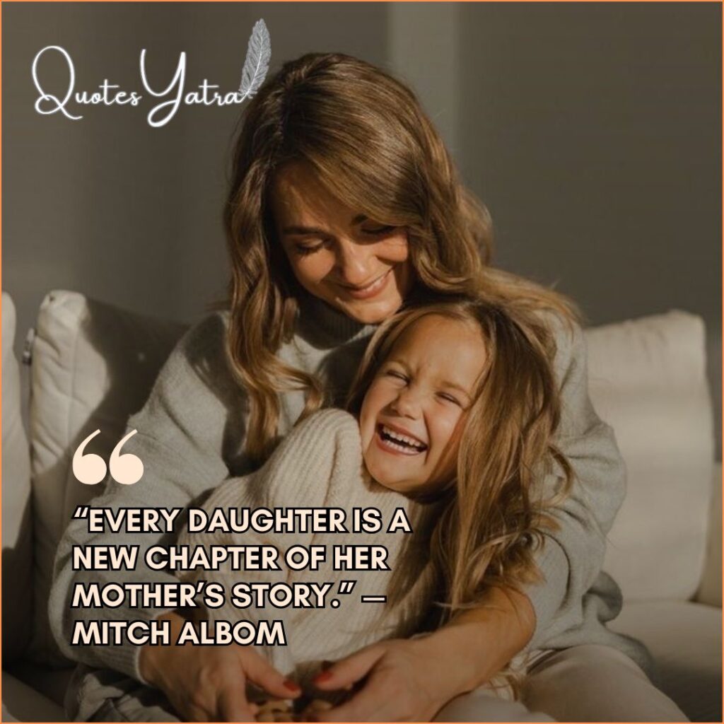 A mother and her young daughter laughing together on a sofa in soft, natural light.