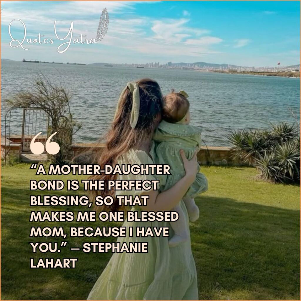 A mother holding her young daughter while looking out over a peaceful waterfront.