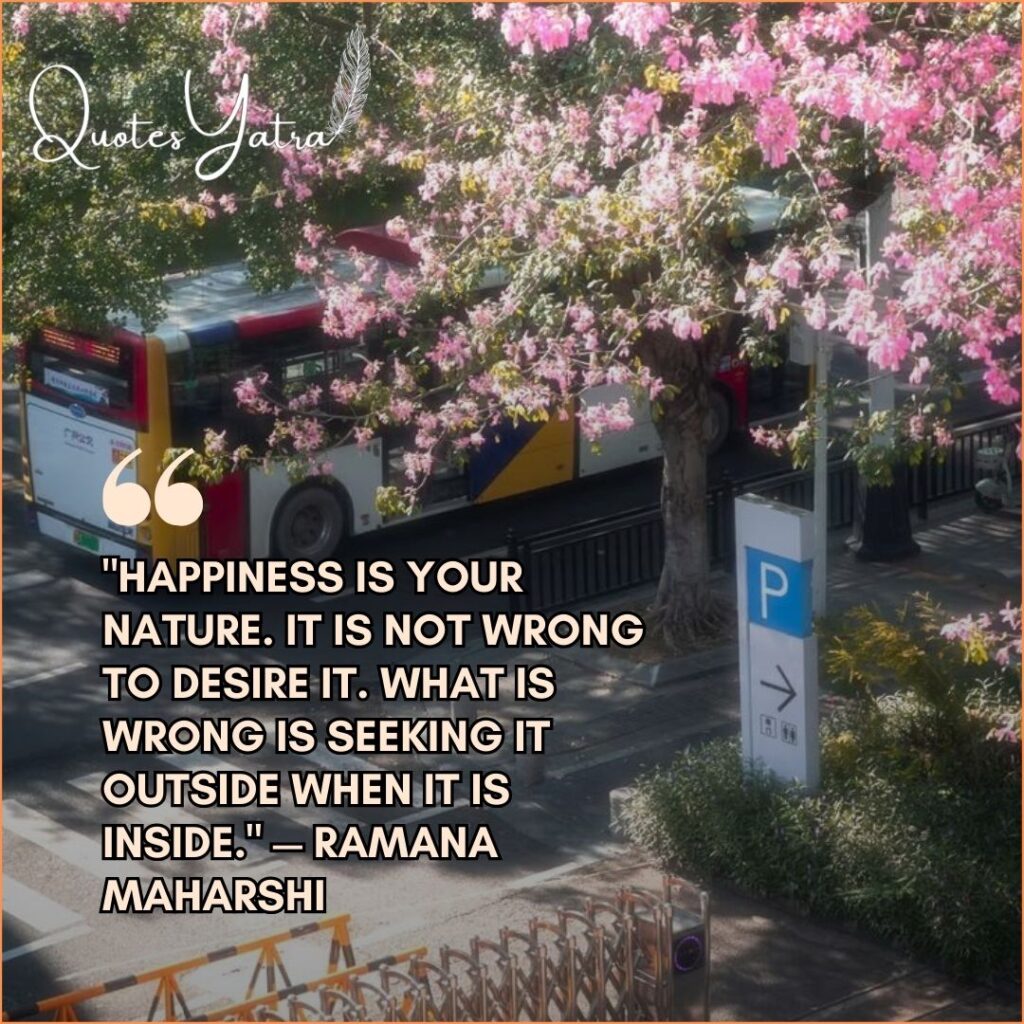 Pink blossoms over a peaceful street with Ramana Maharshi happiness quote about inner joy